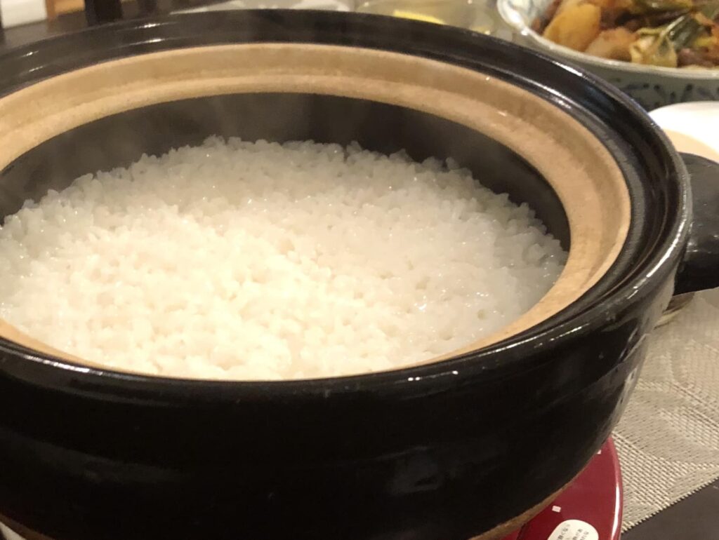 伊賀焼きの土鍋のふたを開け、炊きたてのご飯の様子