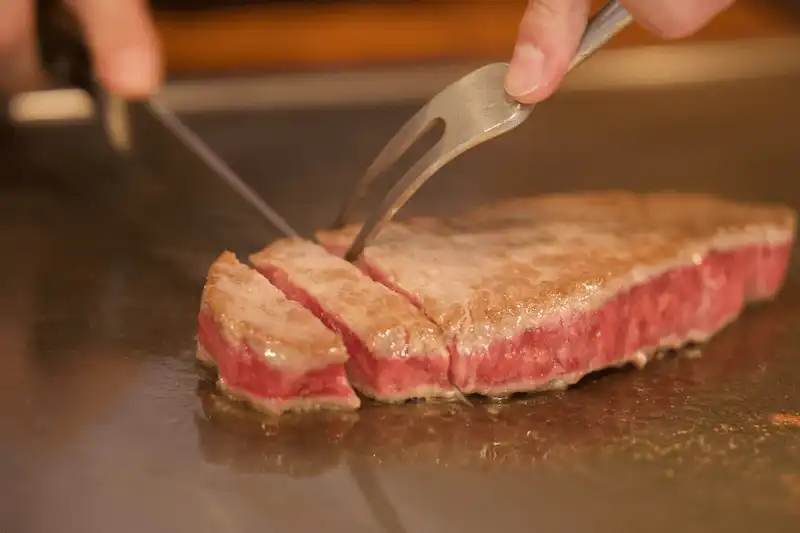 プロが目の前で焼いているステーキの画像