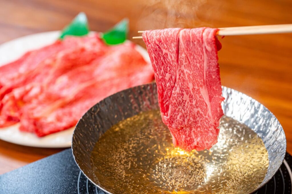 鍋の中でリブロースをしゃぶしゃぶしている様子。薄切り肉を湯にくぐらせている