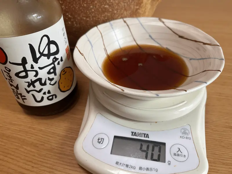 取り皿にいつもの感覚で注いだポン酢をはかりで量った様子。表示は40gで、食塩相当量は約3.1g